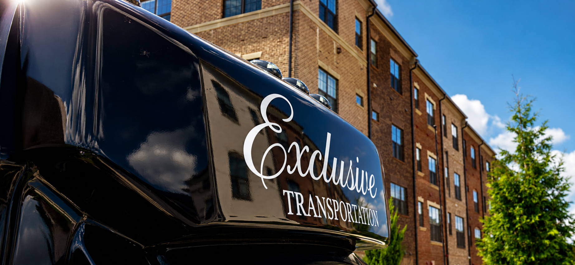 Exclusive Transportation luxury vehicle with branded signage
